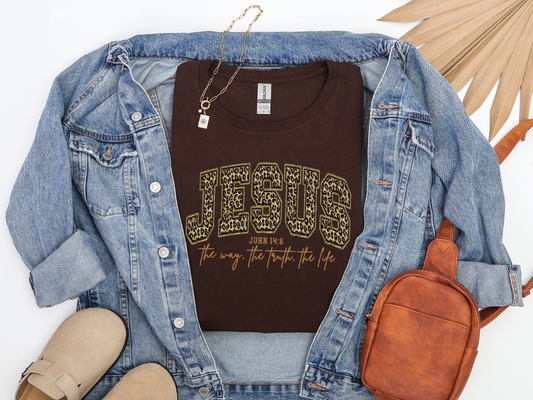 Dark chocolate Jesus John 14:6 Christian graphic tee with leopard-print varsity lettering in a styled flat-lay.
