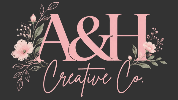 Logo of A&H Creative Co with pink text and floral elements on a black background