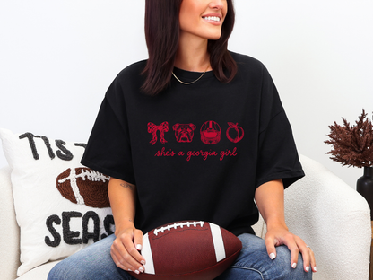 Woman wearing a black She’s a Georgia Girl football graphic tee with red design