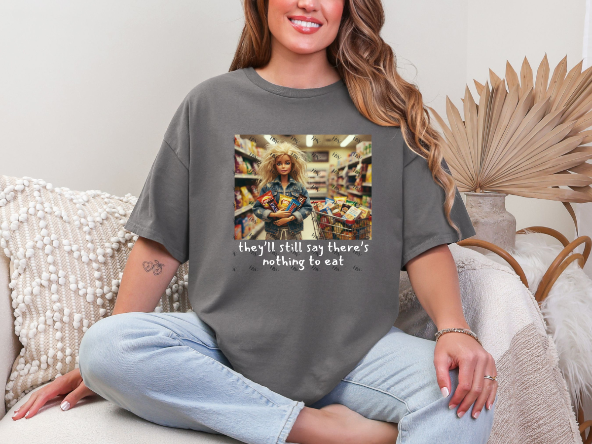 Woman wearing a charcoal-gray There’s Nothing to Eat funny mom graphic tee with grocery-shopping artwork