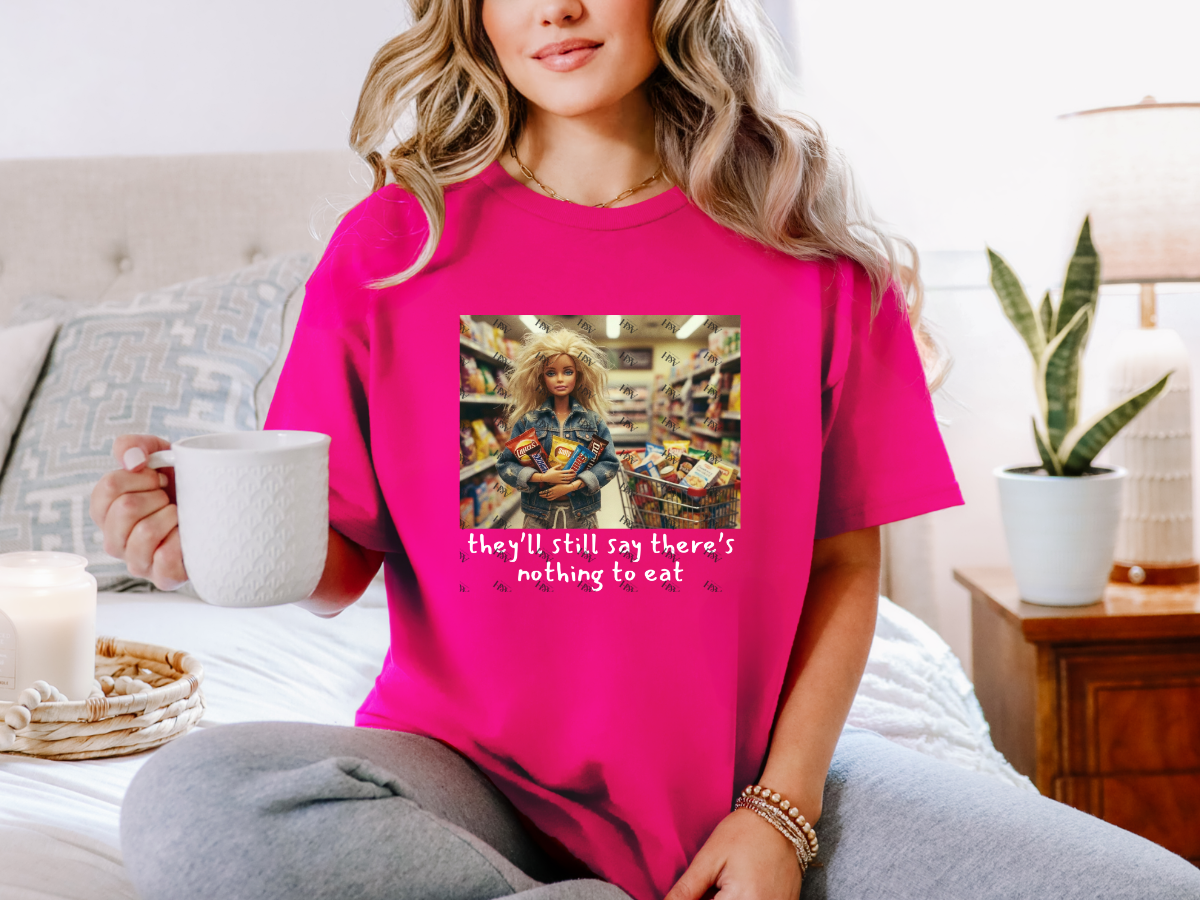 Woman wearing a heliconia-pink There’s Nothing to Eat funny mom graphic tee with grocery-shopping artwork