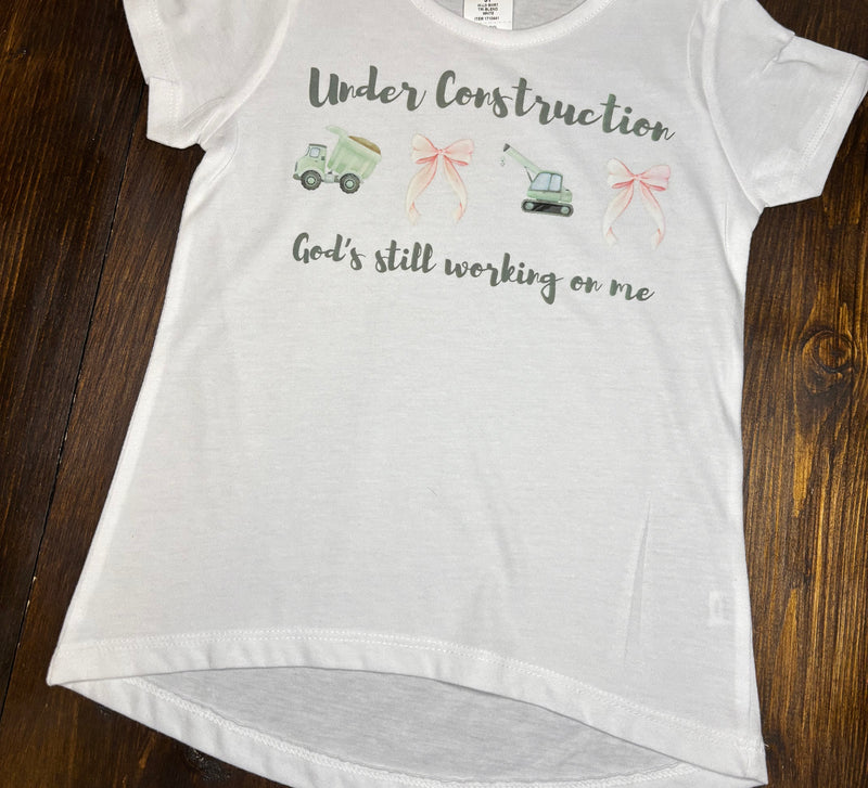 White t-shirt with text and graphics on a wooden surface