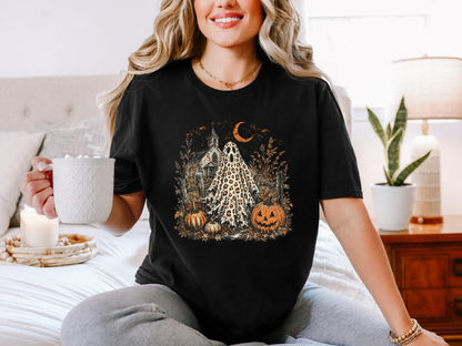 Woman wearing a black leopard ghost Halloween graphic tee with pumpkins and a vintage church design