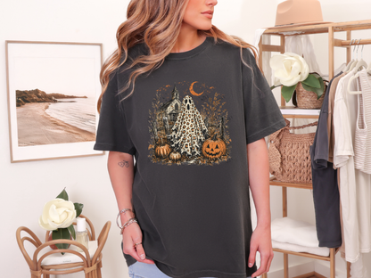 Woman wearing a charcoal leopard ghost Halloween graphic tee in a boutique setting