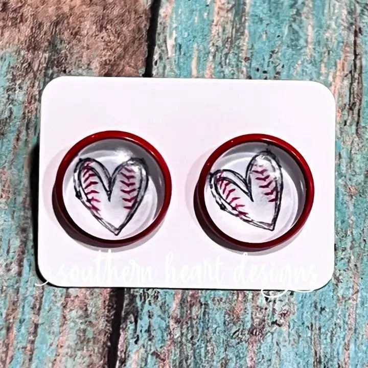 Red round stud earrings featuring white hearts with baseball stitching