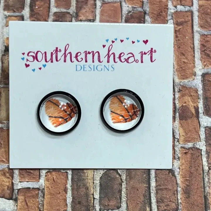 Round black stud earrings featuring orange basketball designs