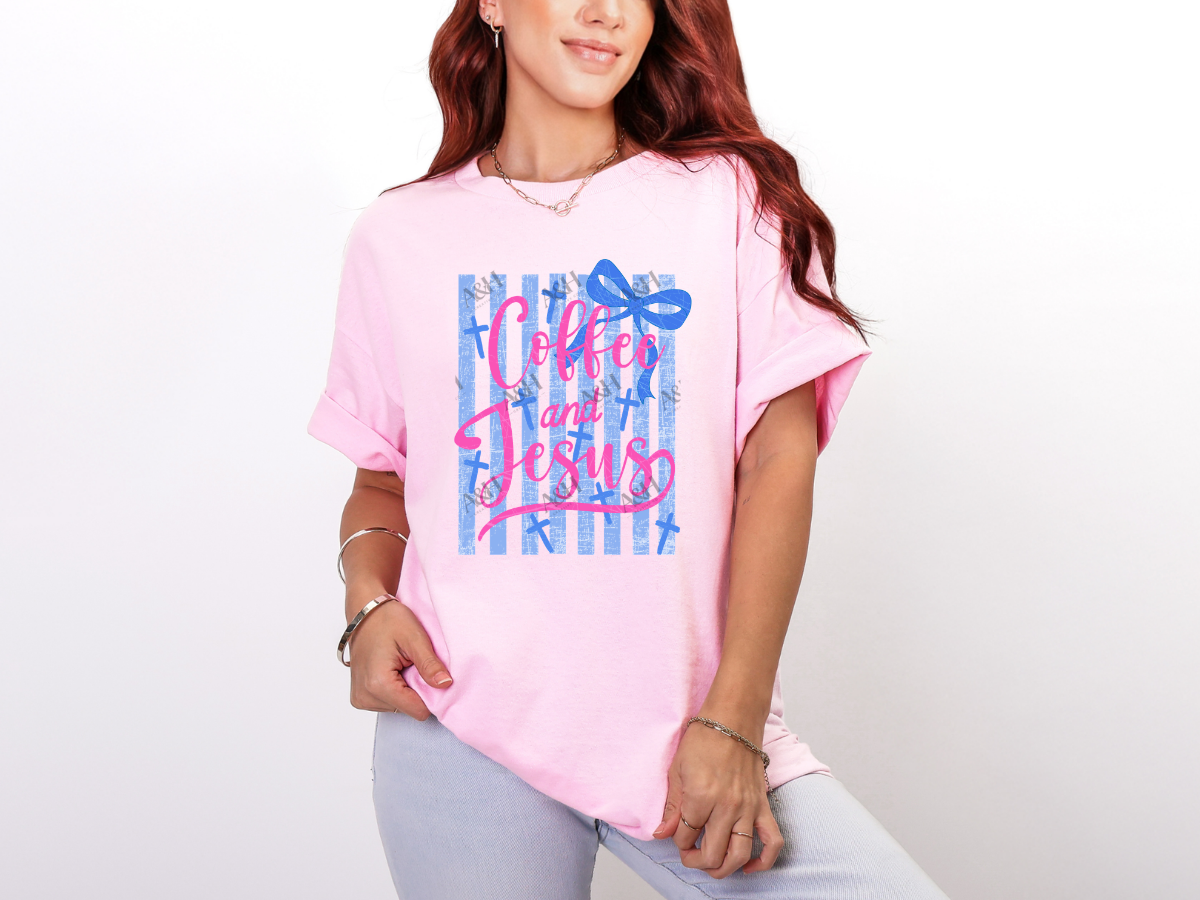 Woman wearing a pink Coffee and Jesus Christian graphic tee with blue stripes, crosses, and a bow