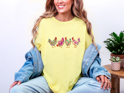 Woman wearing a yellow colorful chicken graphic tee with four bright farmhouse hens and a denim jacket