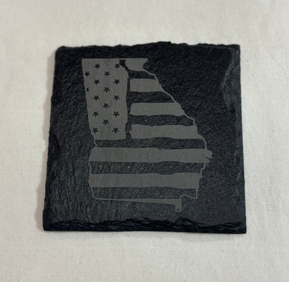 Square black slate coaster engraved with a Georgia state silhouette filled with American flag stars and stripes.
