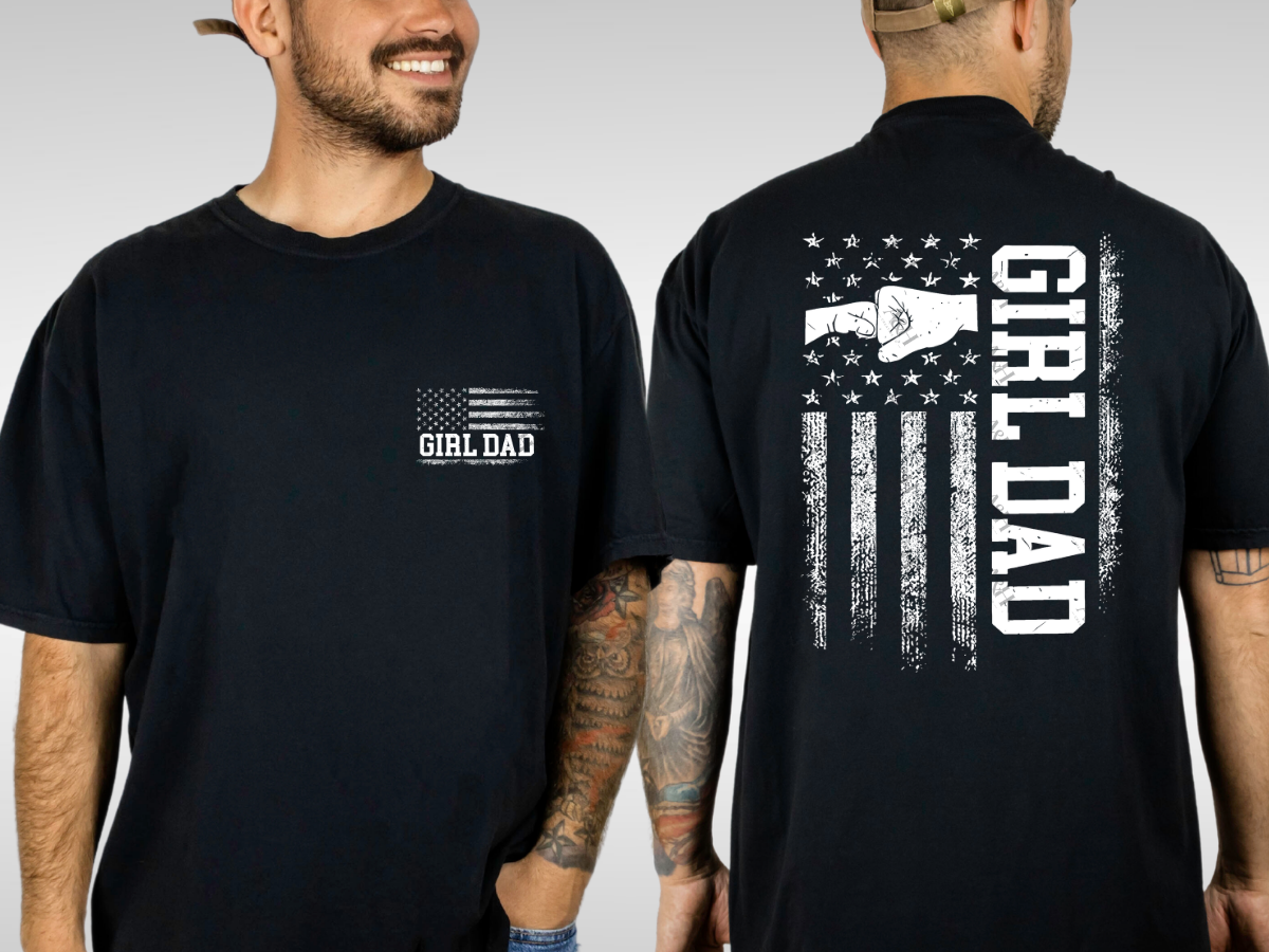 Black Girl Dad graphic tee with distressed American flag pocket design featuring bows and bold black lettering.