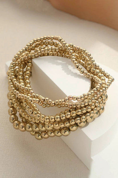 Gold beaded bracelet stack with mixed-size stretch bracelets for women