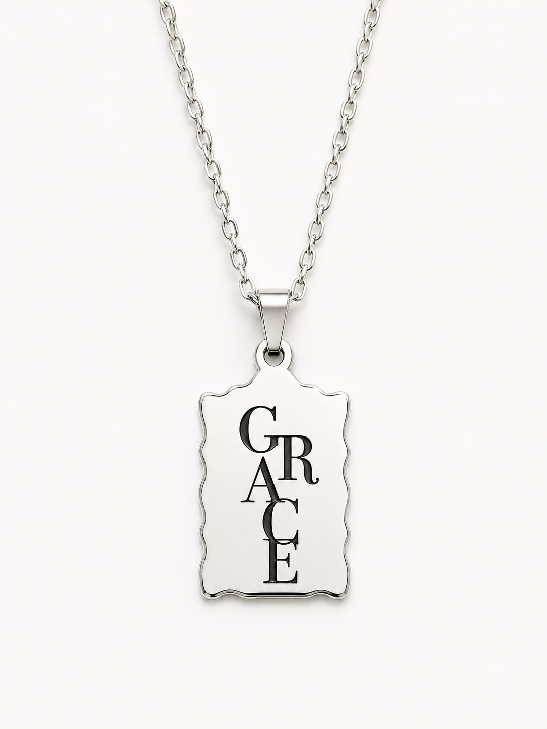 Minimalist silver Christian necklace featuring a scalloped bar pendant engraved with the word "Grace" in elegant black typography.