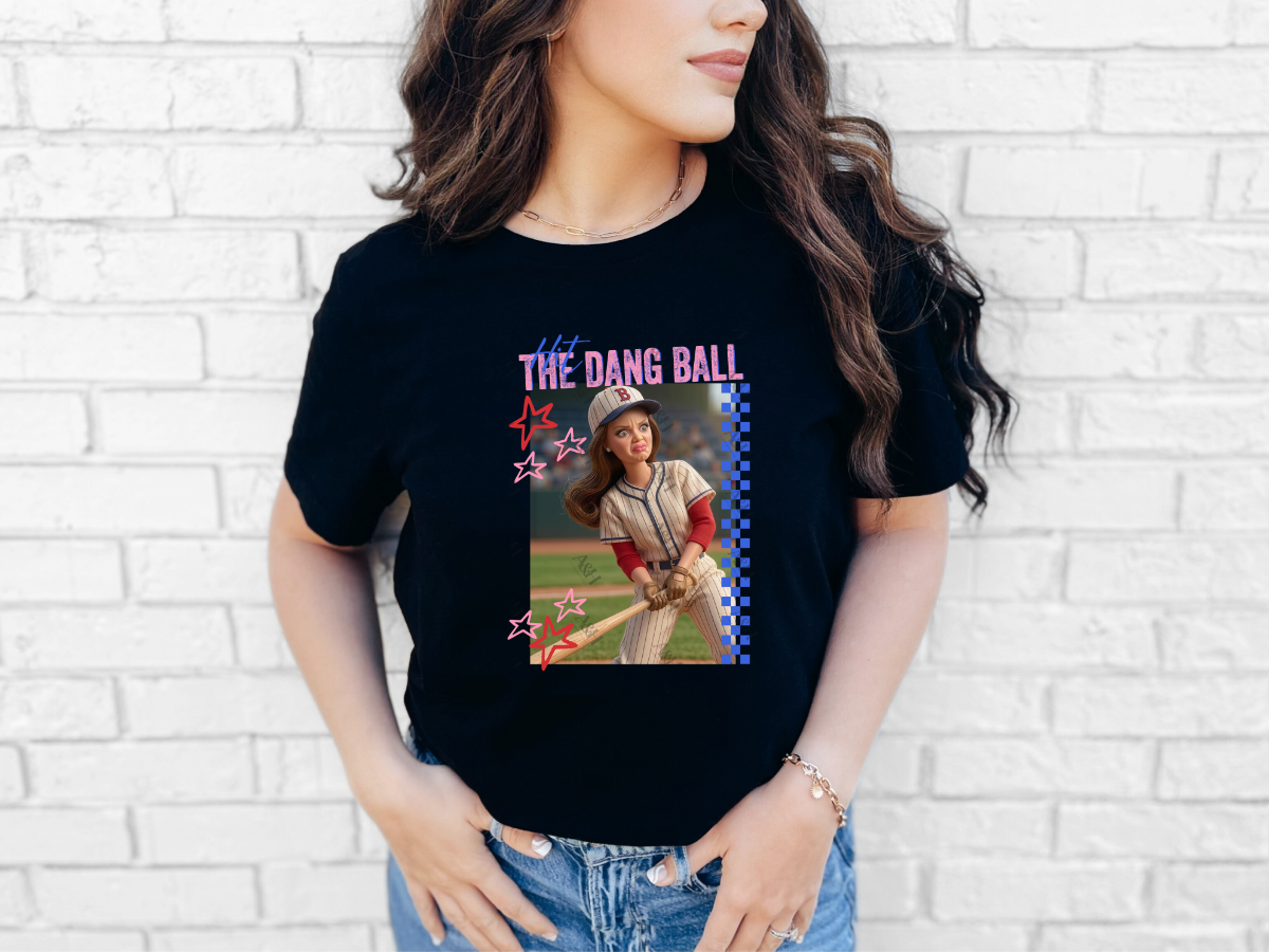Woman wearing a black Hit the Dang Ball baseball graphic tee with a retro female baseball player design