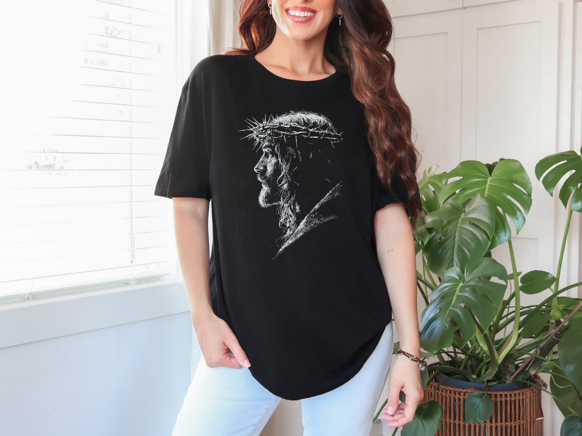 Model wearing a black Jesus Crown of Thorns Christian graphic tee with a white sketch-style portrait design