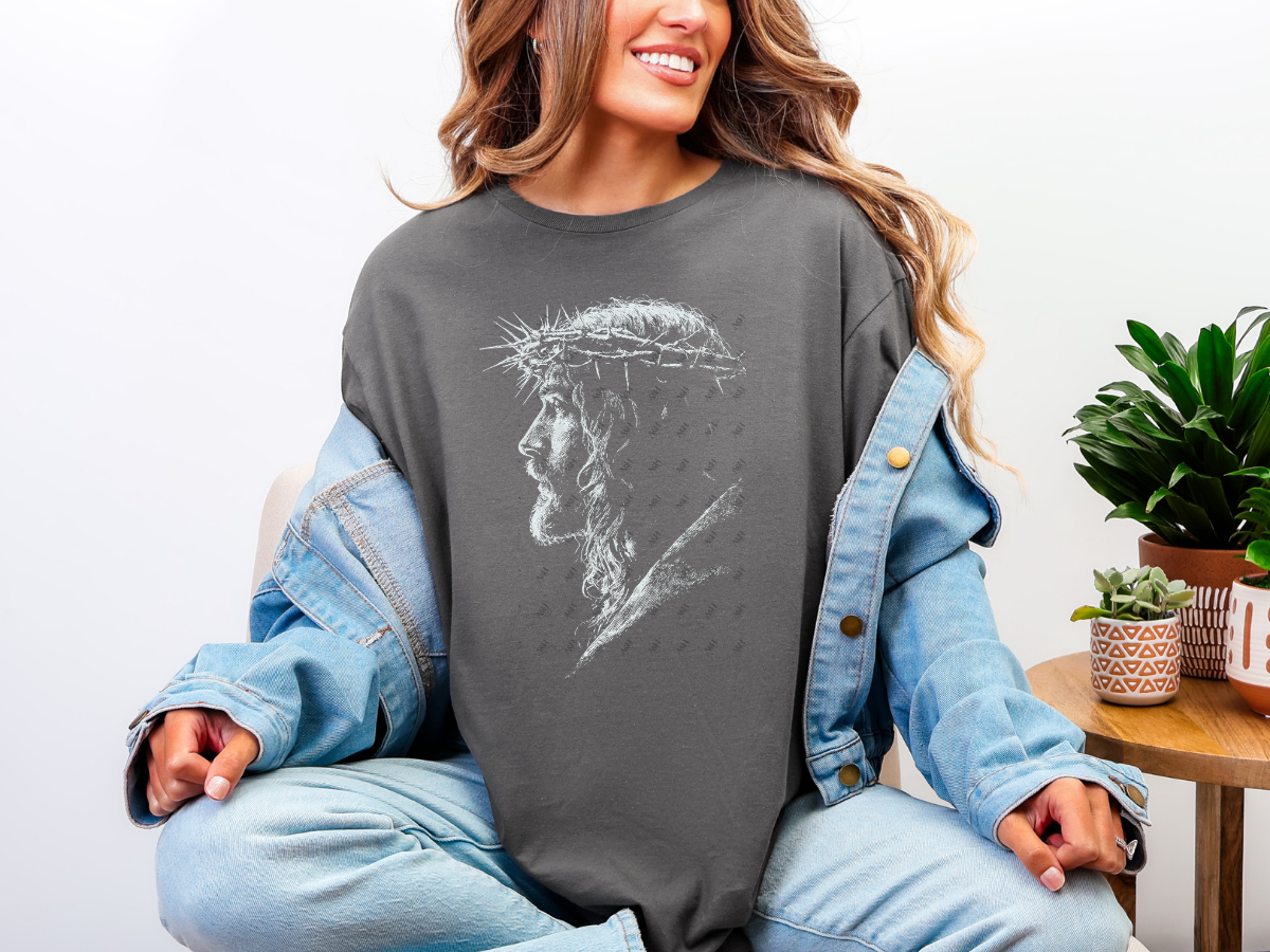 Model wearing a charcoal Jesus Crown of Thorns Christian graphic tee styled with a denim jacket.