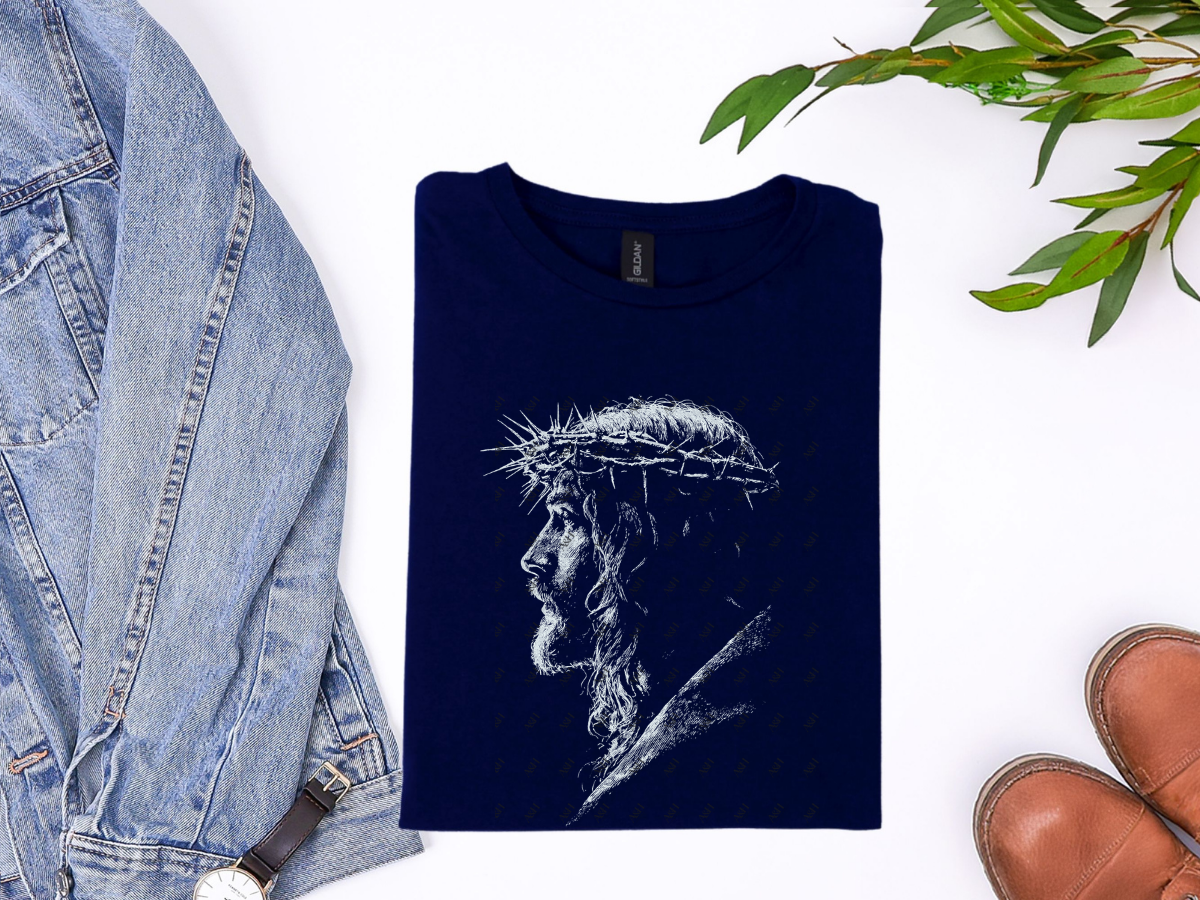 Navy Jesus Crown of Thorns Christian graphic tee with a white portrait design in a styled flat-lay.