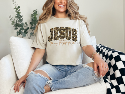 Model wearing a natural Jesus John 14:6 Christian graphic tee with leopard-print lettering and script detail.