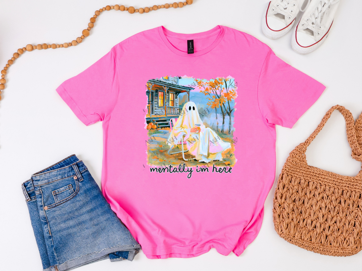 Bright pink Mentally I’m Here Halloween graphic tee featuring two ghosts relaxing outside a fall cabin