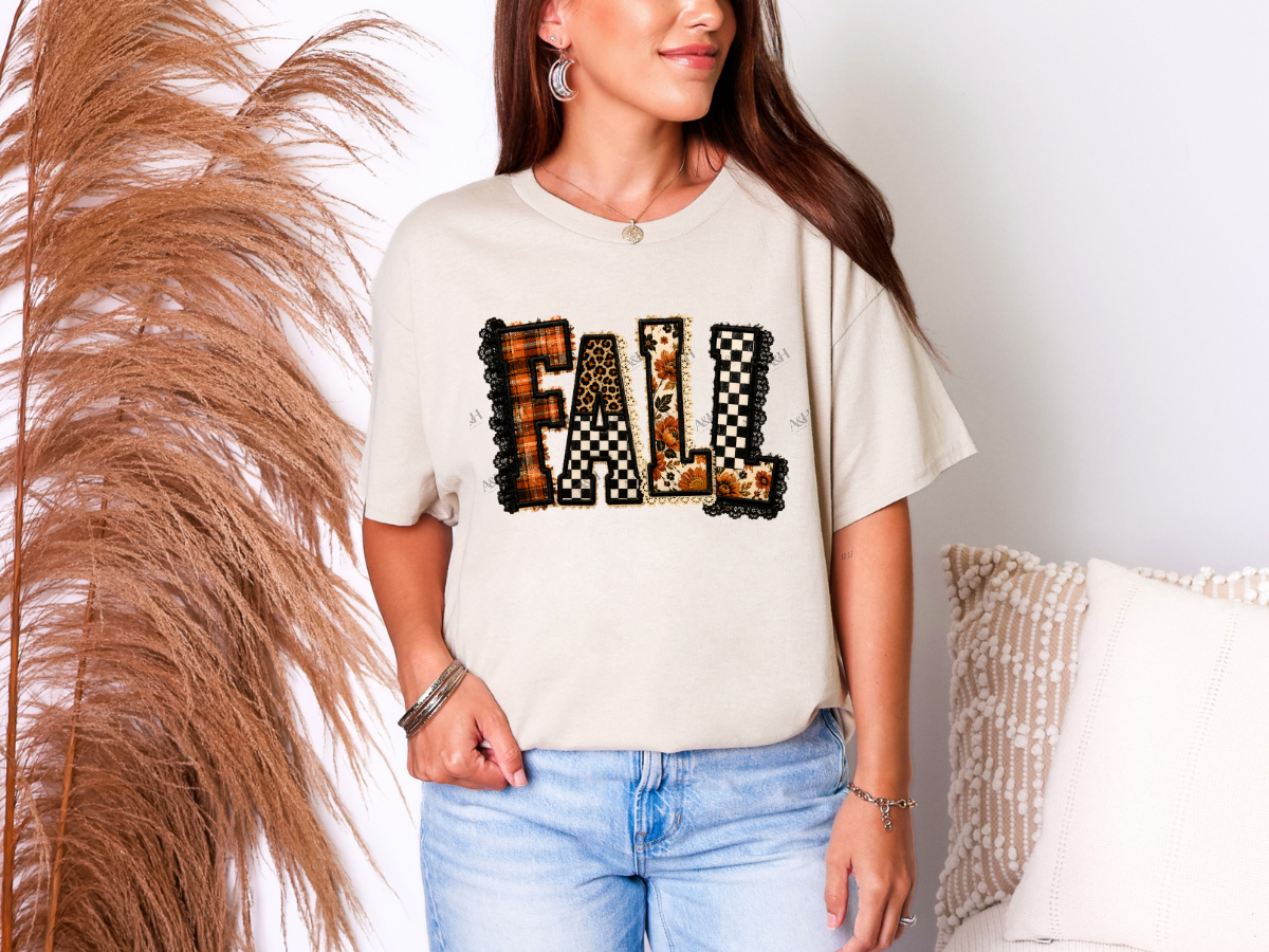Woman wearing a cream patchwork Fall graphic tee with plaid, leopard, floral and checkerboard lettering